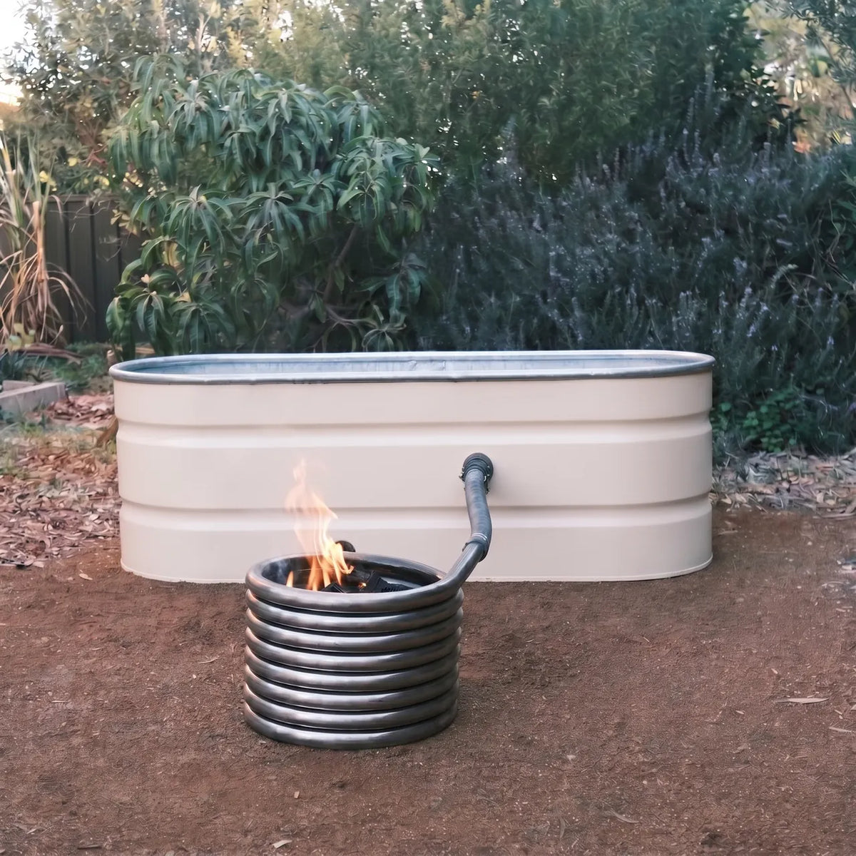 Sandstone Raptor coated Off-Grid Wood Fired Hot Tub with the coil kit lit
