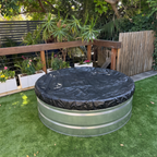 Stock tank pool in backyard with cover