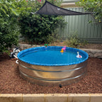 stock tank pool in a backyard with a linler