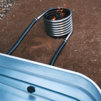 Off grid wood fired coil kit with fire close up with tub