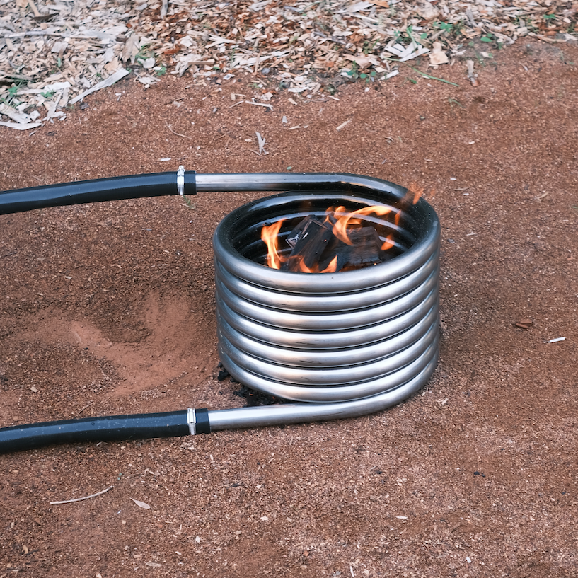 Off grid wood fired coil kit with fire outdoors