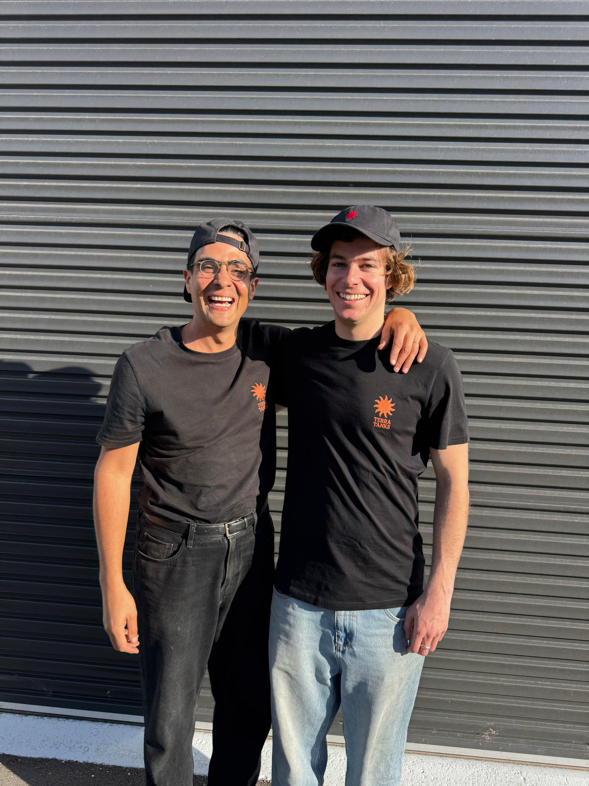 Eduardo and George, co-founders of Terra Tanks, standing in front of a galvanized stock tank pool in Perth